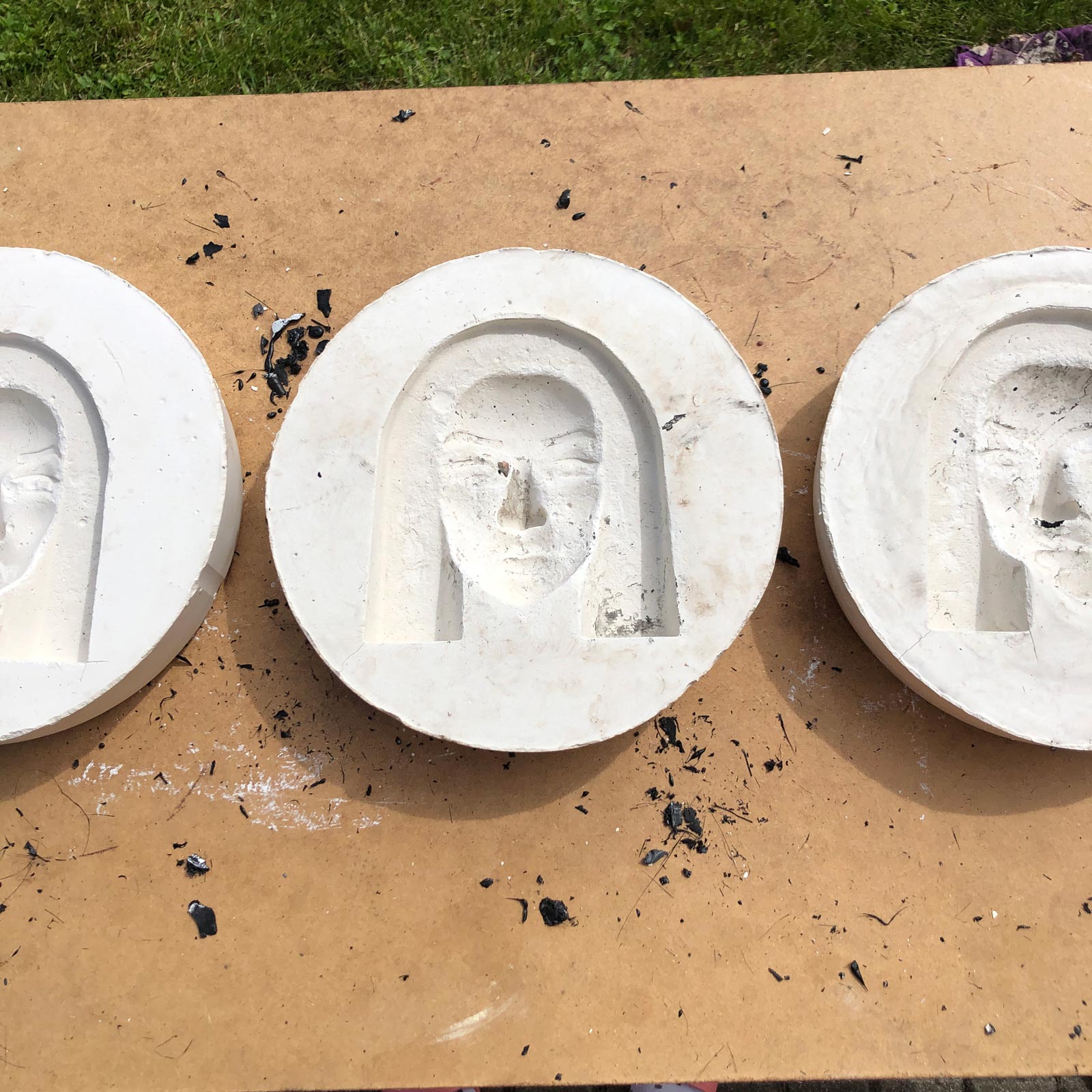 Gypsum molds used for shaping plastic straw sculptures, an essential step in the process of transforming melted art straws into unique facial forms.