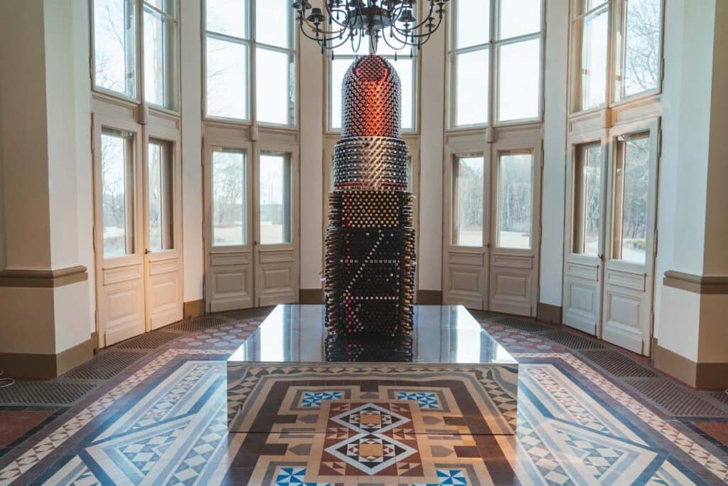 Full view of Giant Lipstick waste art sculpture.