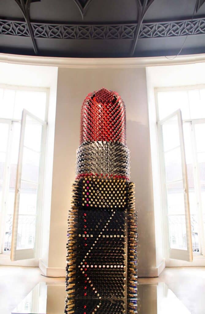 Giant Lipstick waste art object photographed from below showing its height and design.