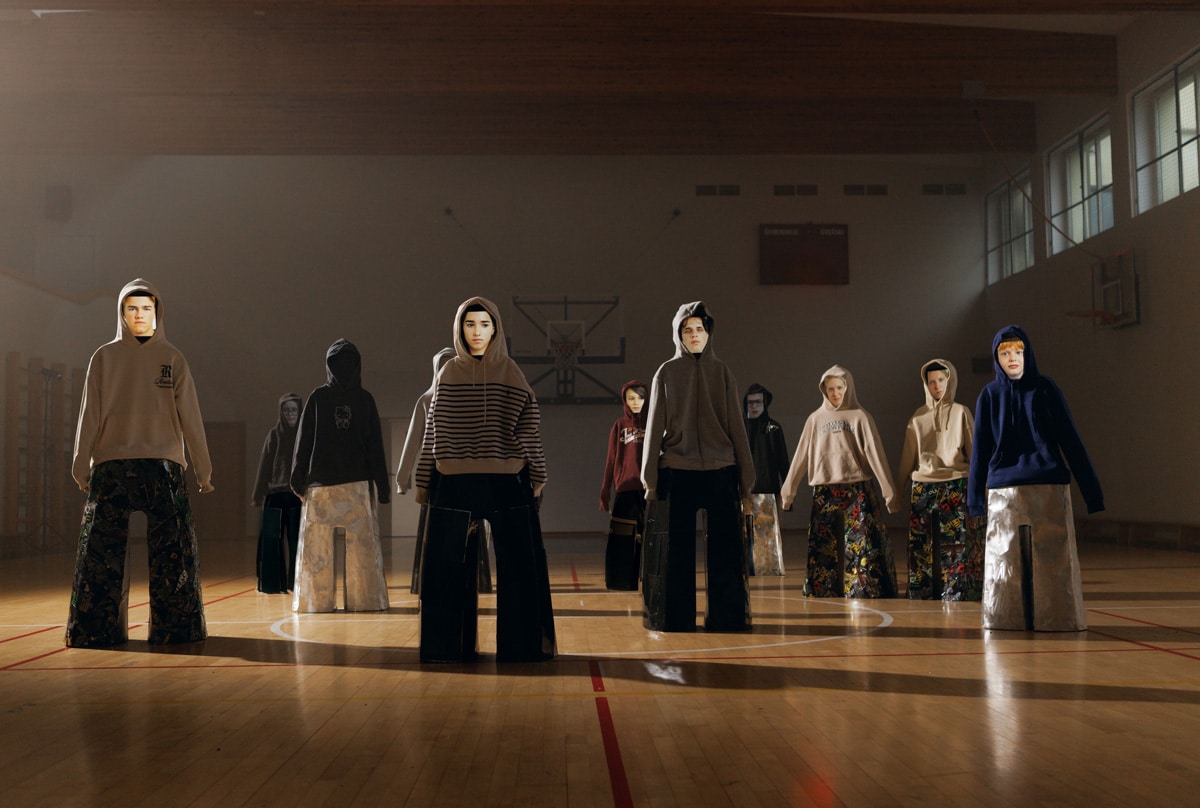 Group of hooded metal and textile figures from Adolescence art installation by Agne Kisonaite, representing teenage emotional well-being and silence inside a school gym.