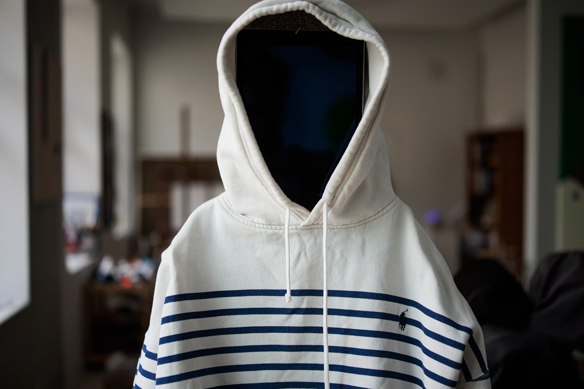 Close-up of a striped hooded figure from the Adolescence art installation by Agne Kisonaite
