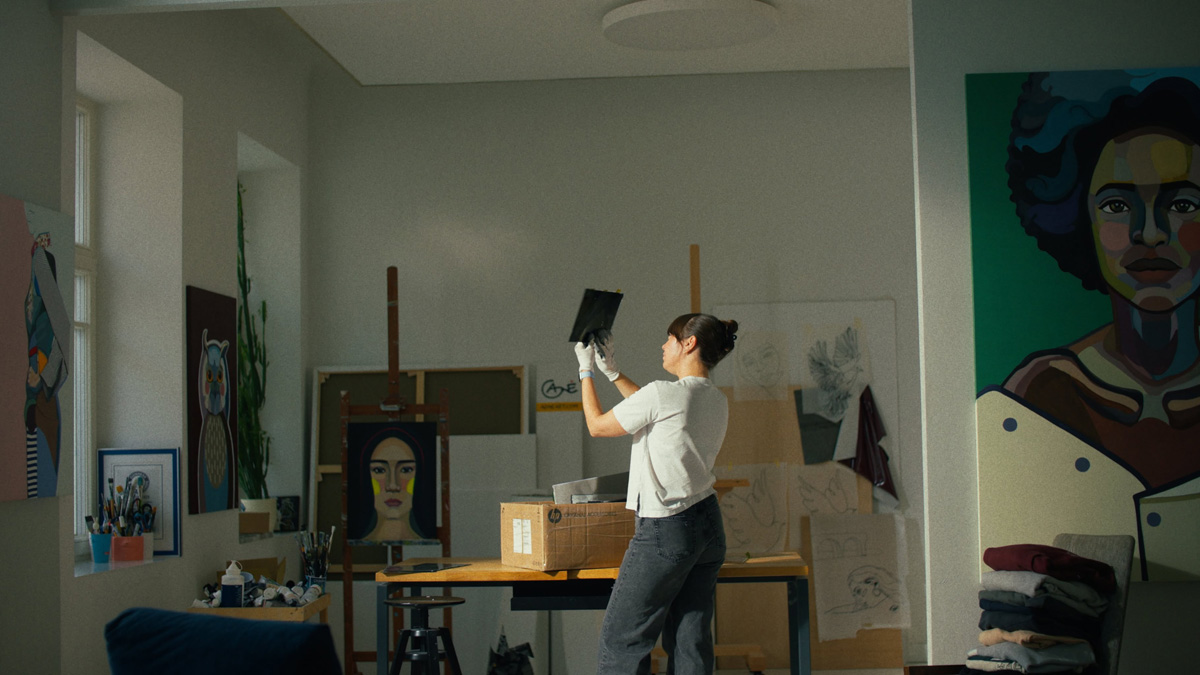 Agne Kisonaite examining a metal component while preparing the Adolescence art installation in her studio